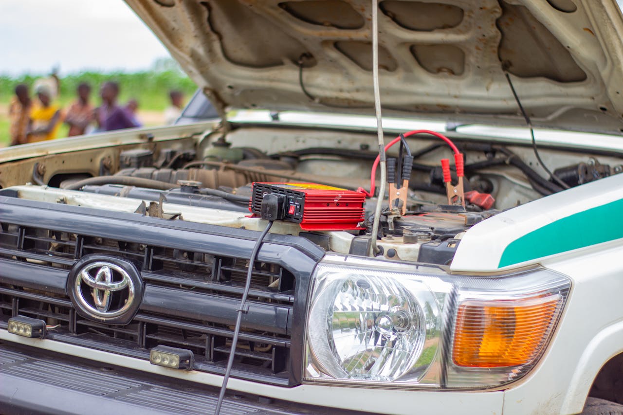 Services Close-up of car engine with battery charger in Blantyre, Southern Region, Malawi.